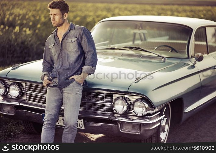 Elegant male model with the blue retro car