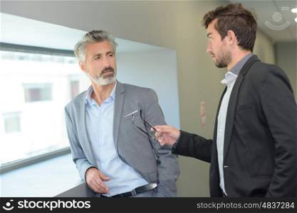 elegant man talking to his workmate with the gesticulation