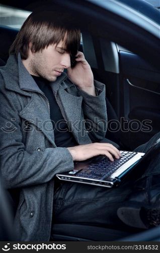 Elegant man working in a car