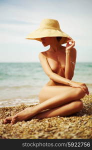 Elegant naked lady at the sea. Summer travel photos