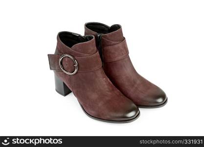 Elegant outfit. CloseUp of stylish suede ankle boots isolated on white background. City lifestyle. Female fashion.