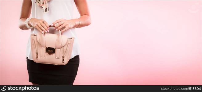 Elegant outfit. Female fashion. Girl in fashionable clothes holding bag handbag.