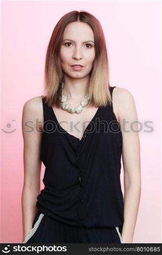 Elegant outfit. Young stylish woman fashionable girl portrait on pink. Fashion and female beauty. Studio shot.