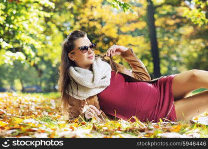 Elegant pregnant mother in the park