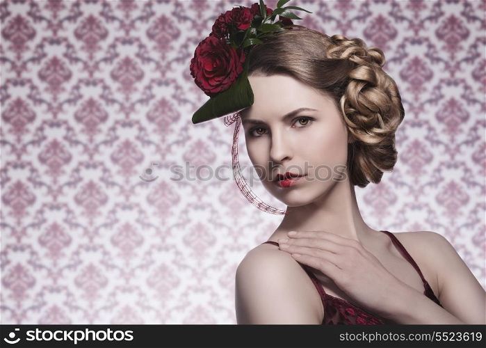 elegant pretty girl with creative romantic hair-style, red roses on her head, sexy red dress and heart shaped lipstick