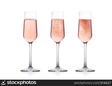 Elegant Rose pink champagne glasses with bubbles on white background with reflection
