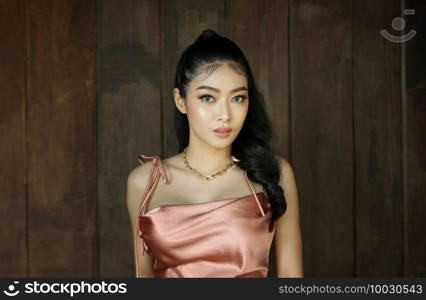 elegant sensual young woman in brown dress on recamier outdoor shot