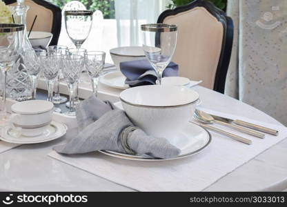 elegant table set on marble dining table in vintage style dining room interior. elegant table set on marble dining table in vintage style dining