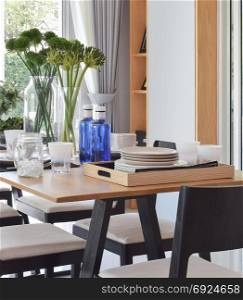 elegant table setting on wooden dining table in modern home