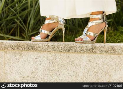 Elegant unrecognizable woman presenting fashionable urban outfit. High heels and trousers culottes.. Woman wearing high heels and culottes
