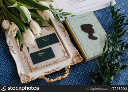 elegant wedding bouquet of fresh natural flowers and greenery with book