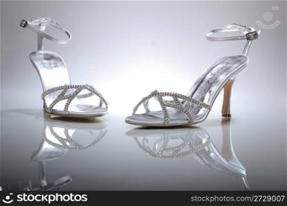Elegant wedding shoes over gradient gray background