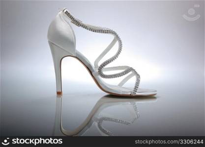 Elegant wedding shoes over gradient gray background