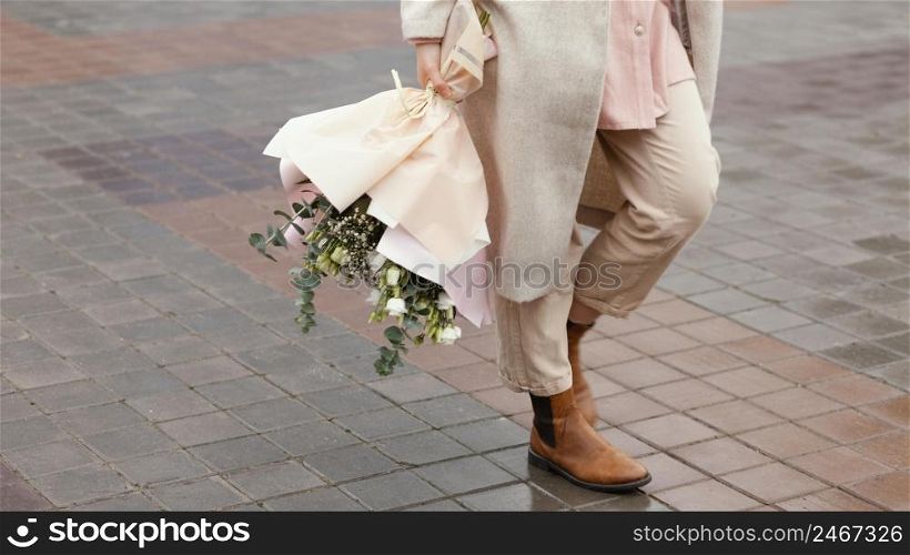 elegant woman city holding bouquet flowers