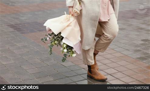 elegant woman city holding bouquet flowers