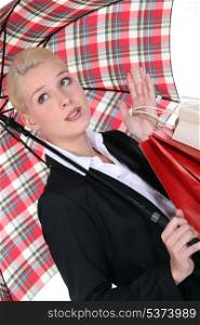 elegant woman holding shopping bags and an umbrella