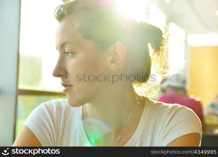 elegant woman in cafe is looking sideways