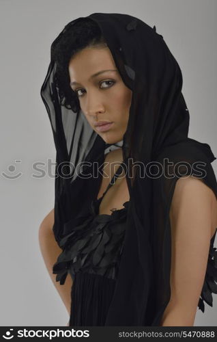 elegant woman in fashionable stylish dress posing in the studio