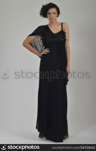 elegant woman in fashionable stylish dress posing in the studio