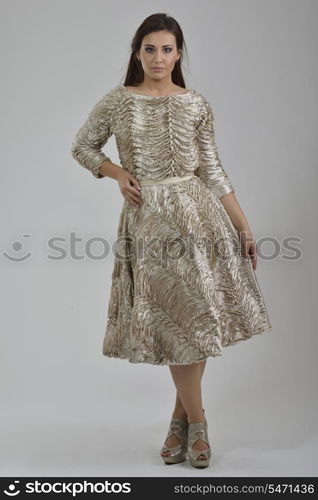 elegant woman in fashionable stylish dress posing in the studio