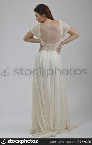 elegant woman in fashionable stylish dress posing in the studio