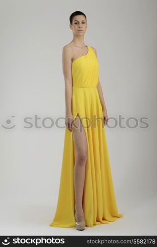 elegant woman in fashionable stylish dress posing in the studio