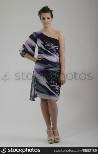 elegant woman in fashionable stylish dress posing in the studio