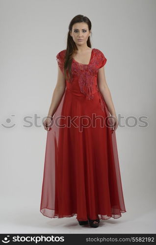 elegant woman in fashionable stylish dress posing in the studio