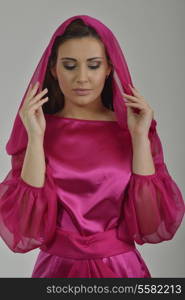 elegant woman in fashionable stylish dress posing in the studio