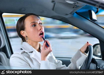 elegant woman is doing makeup on the run in her car