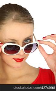 elegant woman looking over her sunglasses