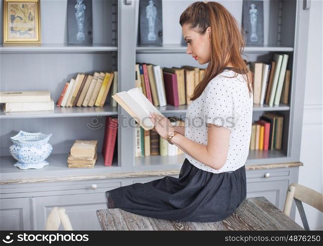 Elegant woman reading an interesting book