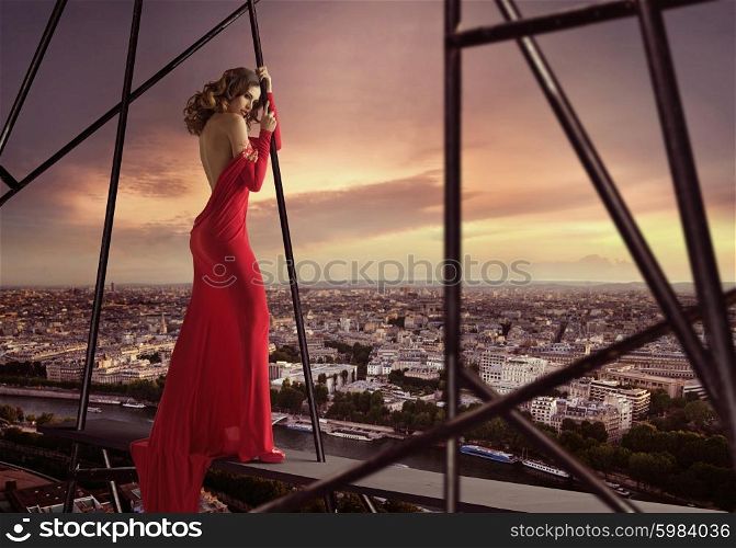 Elegant woman standing on the edge of the roof