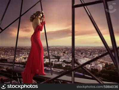 Elegant woman standing on the edge of the roof
