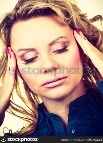 Elegant woman with headache. Overworked blonde female with pain in head. Unhappy business woman have headache. Filtered.