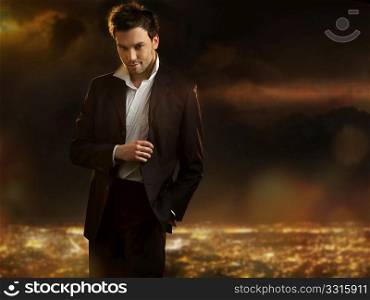 Elegant young handsome man over night city background