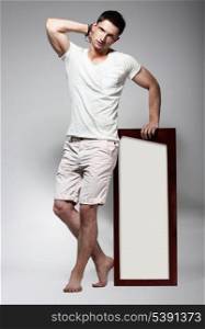 Elegant Young Man in White Cotton Clothes with Board Standing