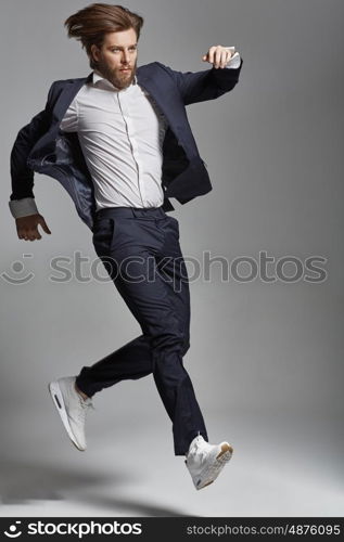 Elegant young man jumping and dancing