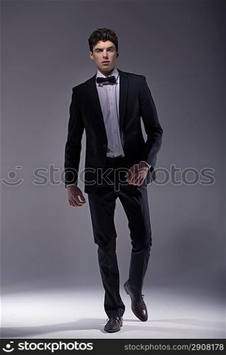 Elegant young muscular model wearing suit