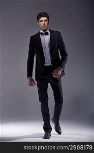 Elegant young muscular model wearing suit