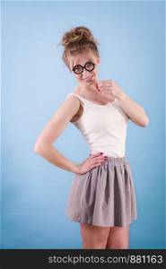 Elegant young woman pretending wearing funny nerd eyeglasses. Education and studying females look concept.. Elegant woman pretending wearing eyeglasses