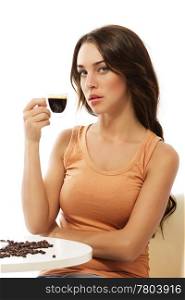 elegant young woman sitting at a table with espresso coffee. elegant young woman sitting at a table with espresso coffee on white background
