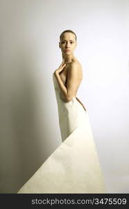 elegante girl with sheet of paper. studio photo.