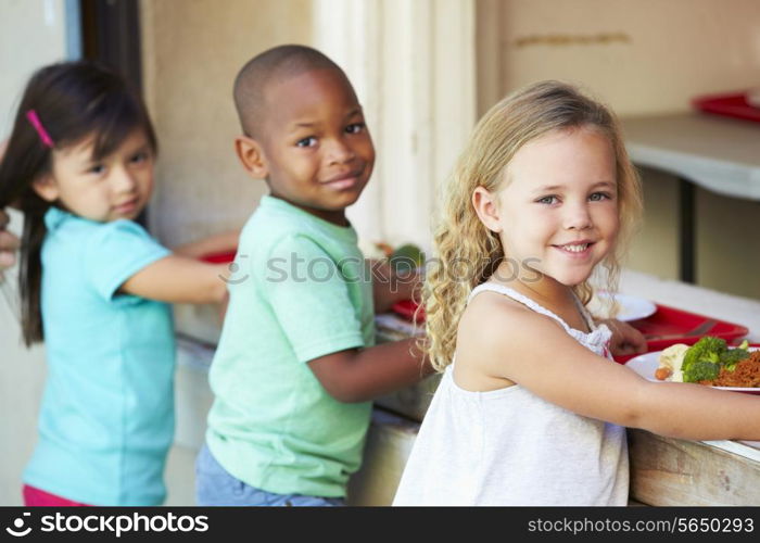 Elementary Pupils Collecting Healthy Lunch In Cafeteria