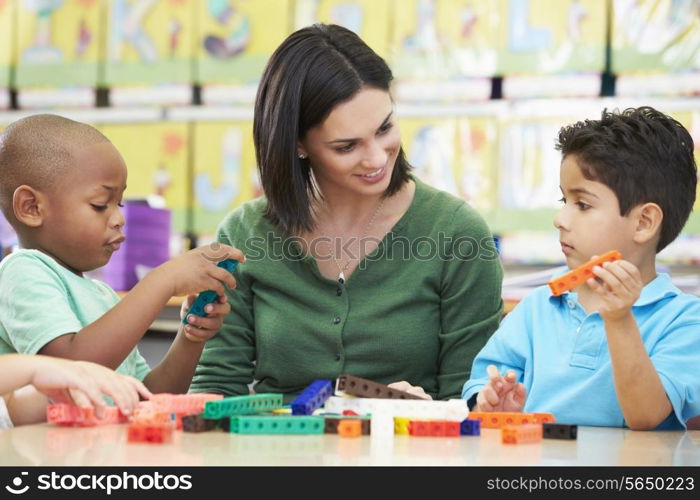 Elementary Pupils Counting With Teacher In Classroom