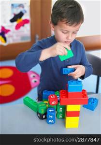 Elementary Student Playing With Building Blocks