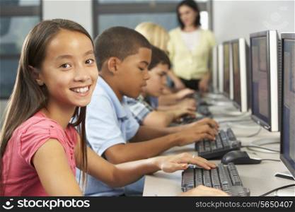 Elementary Students Working At Computers In Classroom