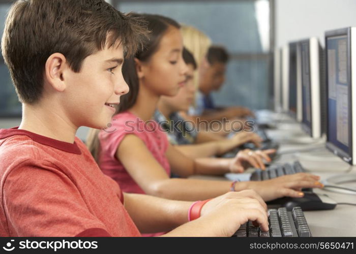 Elementary Students Working At Computers In Classroom