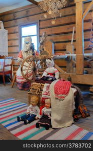 Elements of the old life - spinning wheel, antique clothing, woven basket.