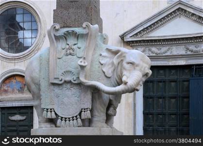 Elephant sculpture by Bernini as the supporting base for the Egyptian obelisk against Saint Mary above Minerva church background in Rome, Italy.